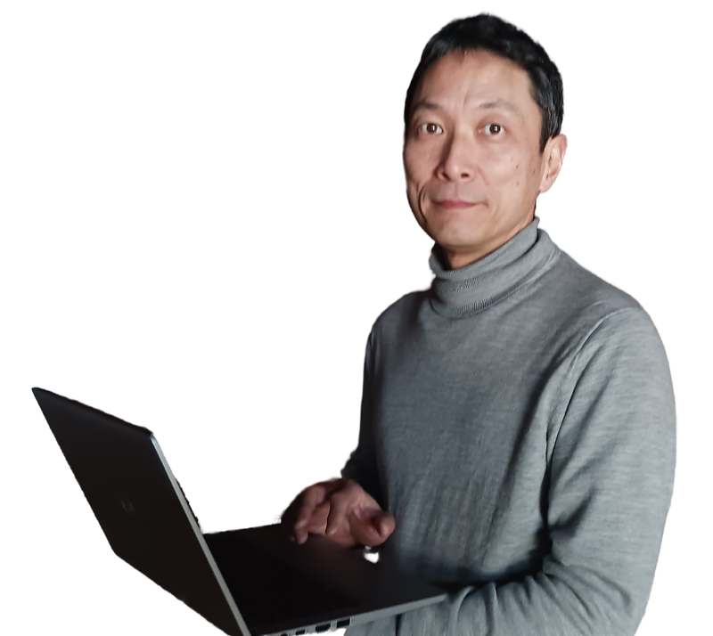 早川スタイル代表。ノートパソコンを持ち、親しみやすい笑顔で写る。紺色のVネックセーターとワイシャツ姿。糸魚川市のパソコンサポート専門家。